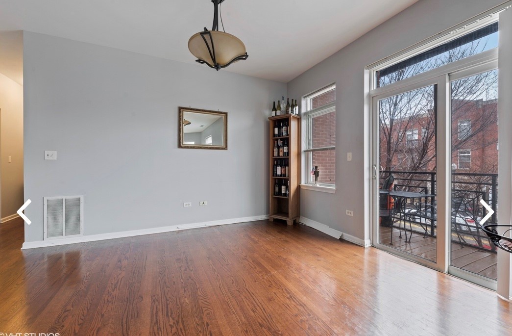 1407 South Halsted Street, Unit 2B Chicago, IL 60607 - Photo 7 of 16 a view of an empty room with wooden floor and a window