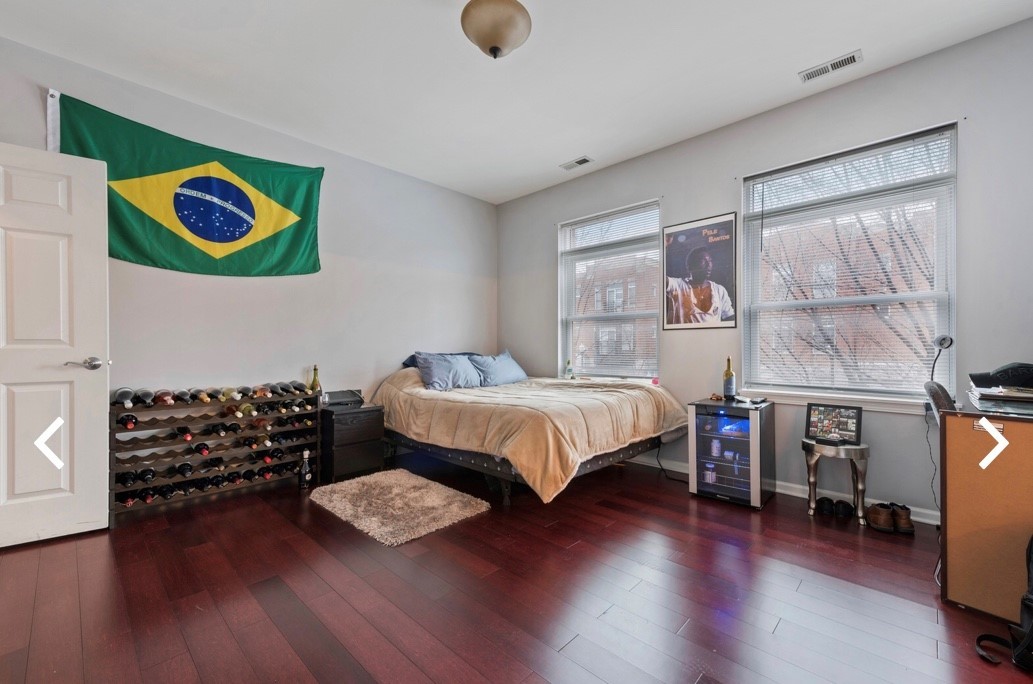 1407 South Halsted Street, Unit 2B Chicago, IL 60607 - Photo 8 of 16 a bedroom with a bed and wooden floor