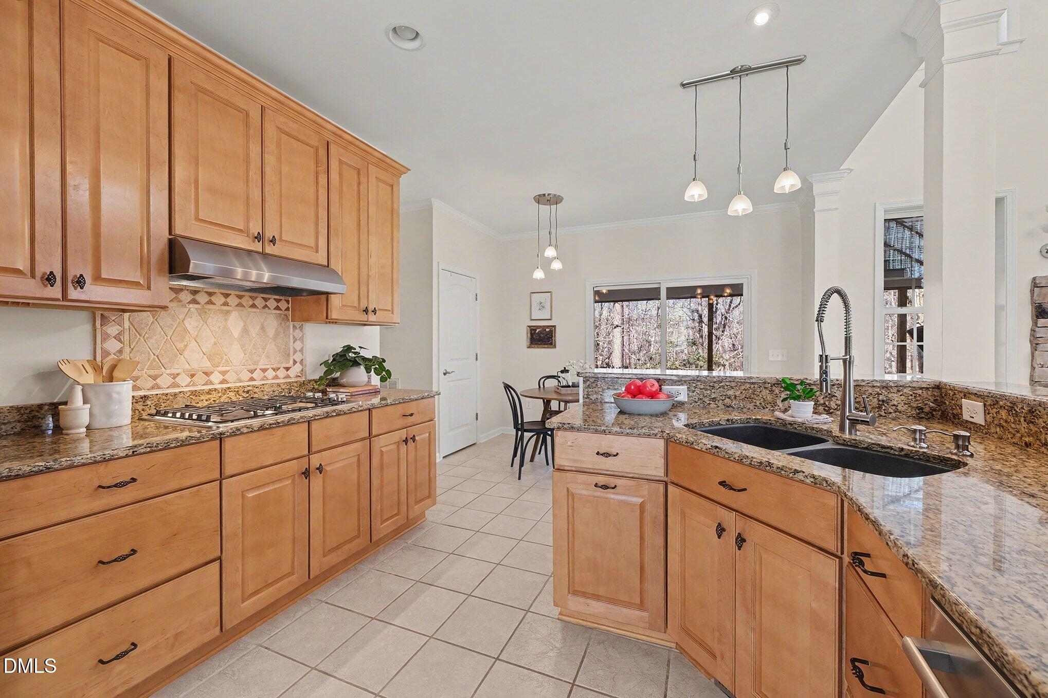 29 Chestnut Bluffs Lane Durham, NC 27713 - Photo 10 of 45 a kitchen with kitchen island granite countertop a sink and white cabinets