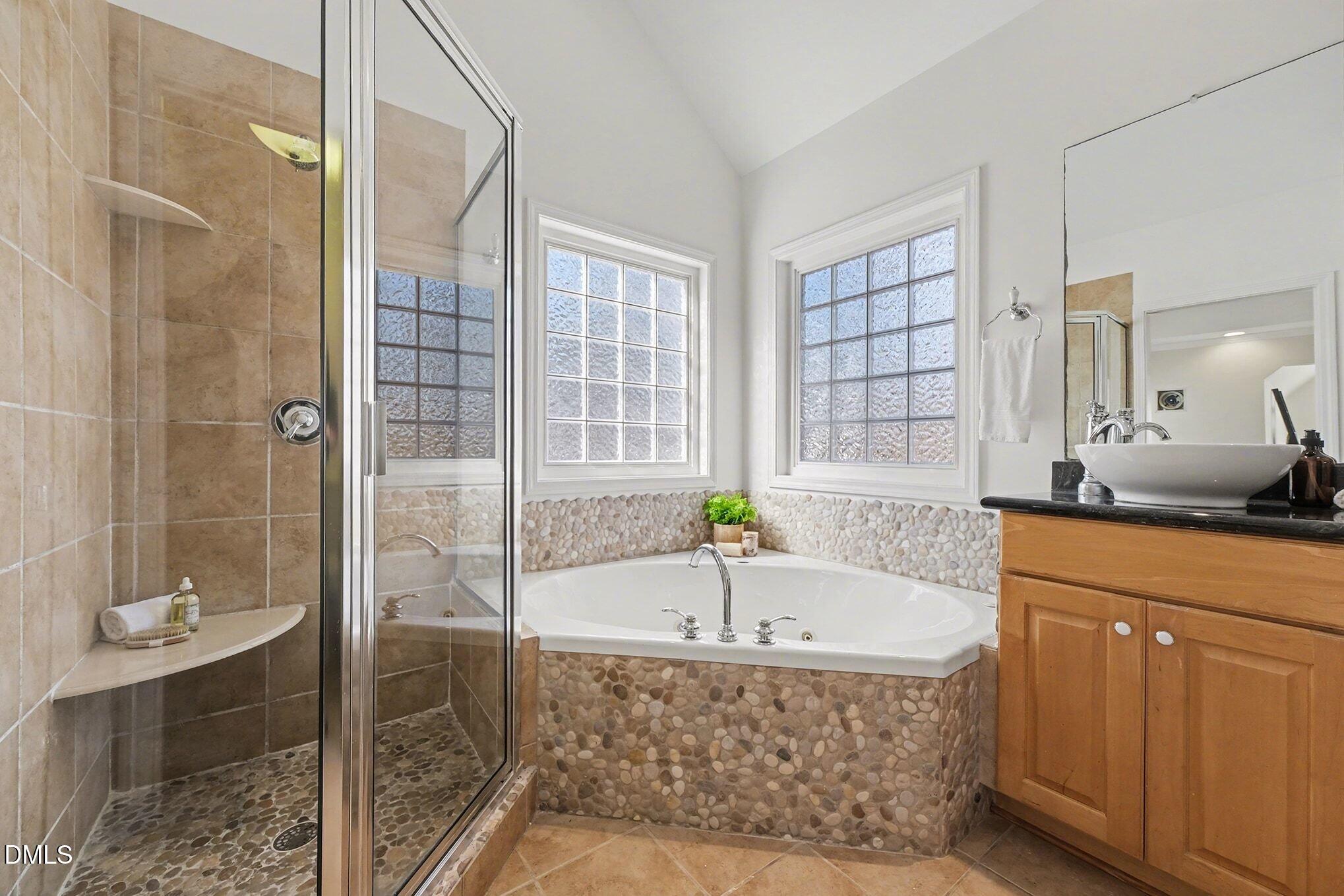 29 Chestnut Bluffs Lane Durham, NC 27713 - Photo 18 of 45 a bathroom with a tub and a shower