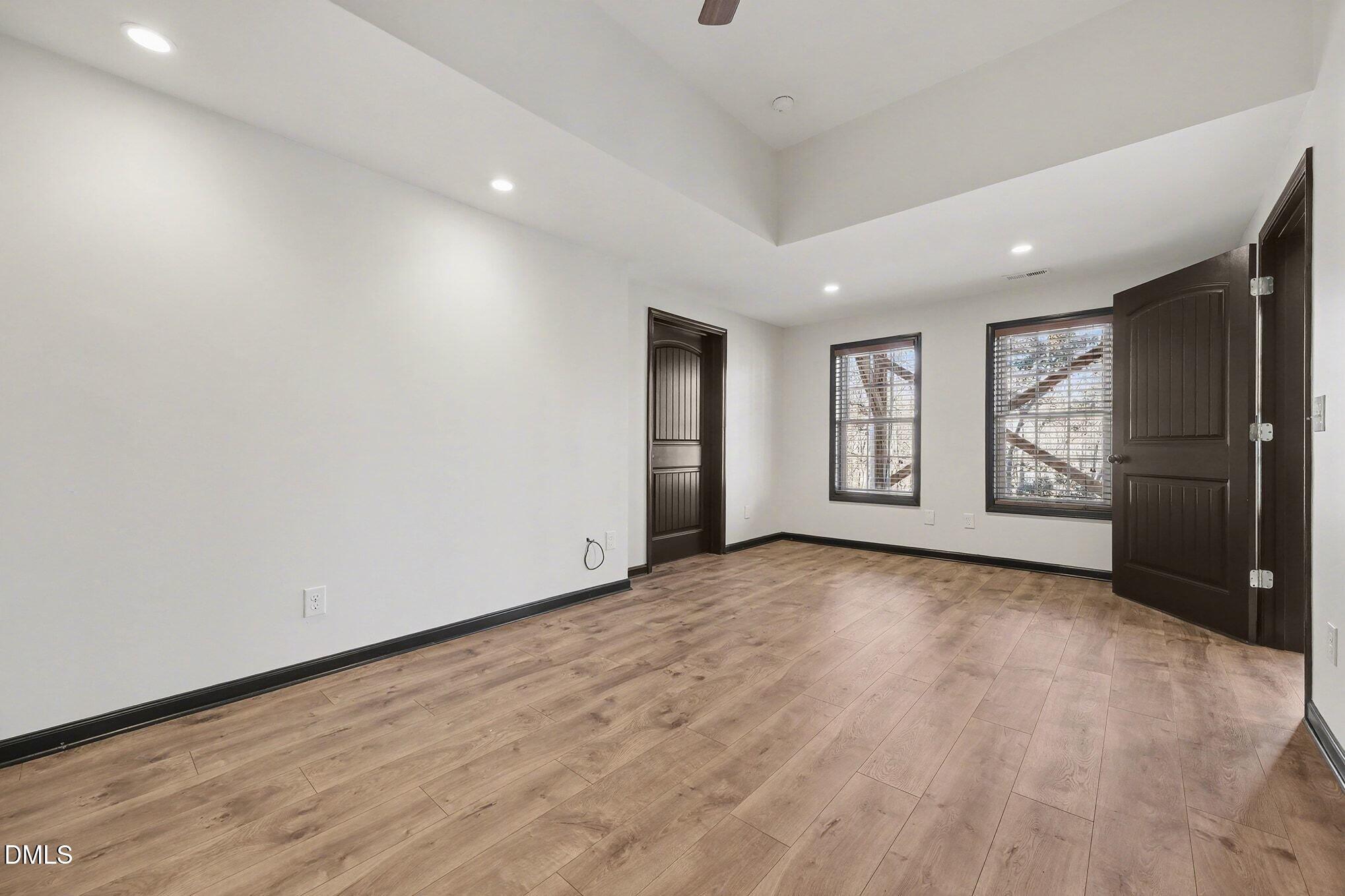 29 Chestnut Bluffs Lane Durham, NC 27713 - Photo 26 of 45 a view of an empty room with a window and wooden floor