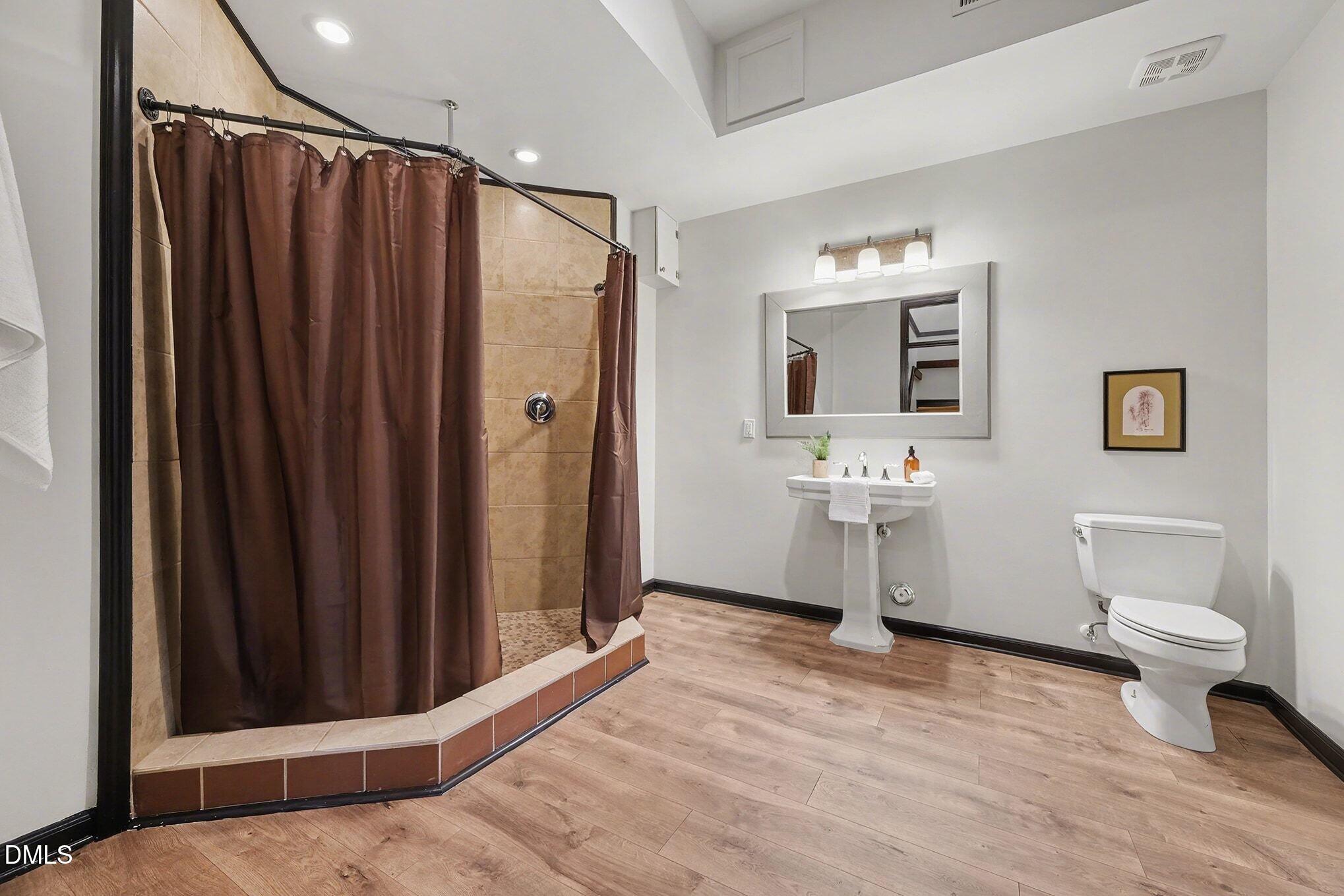 29 Chestnut Bluffs Lane Durham, NC 27713 - Photo 28 of 45 a bathroom with a sink toilet and shower