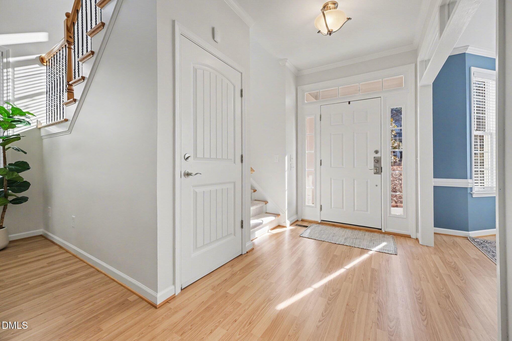 29 Chestnut Bluffs Lane Durham, NC 27713 - Photo 3 of 45 an empty room with wooden floor and windows