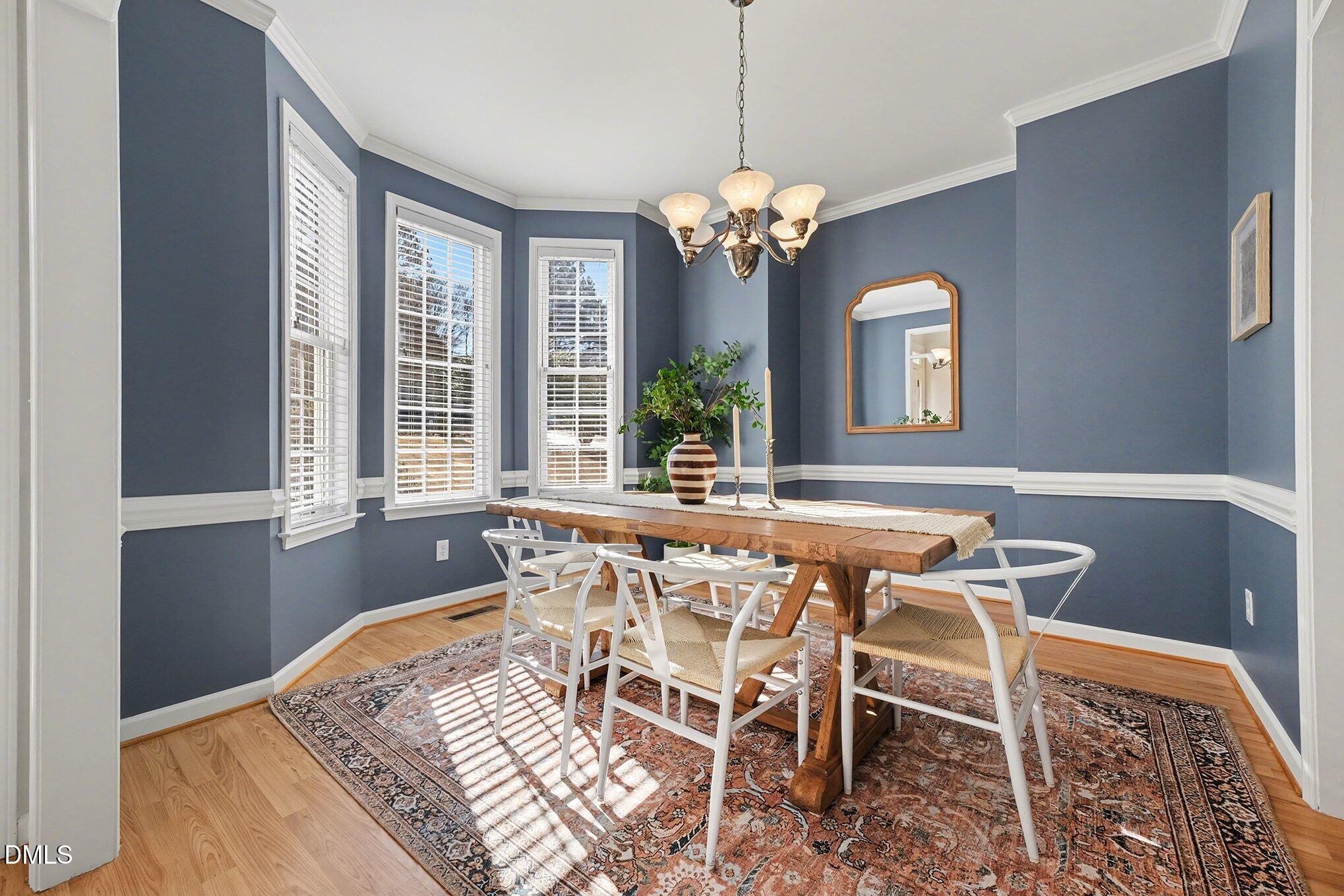29 Chestnut Bluffs Lane Durham, NC 27713 - Photo 7 of 45 a view of a dining room with furniture and a chandelier
