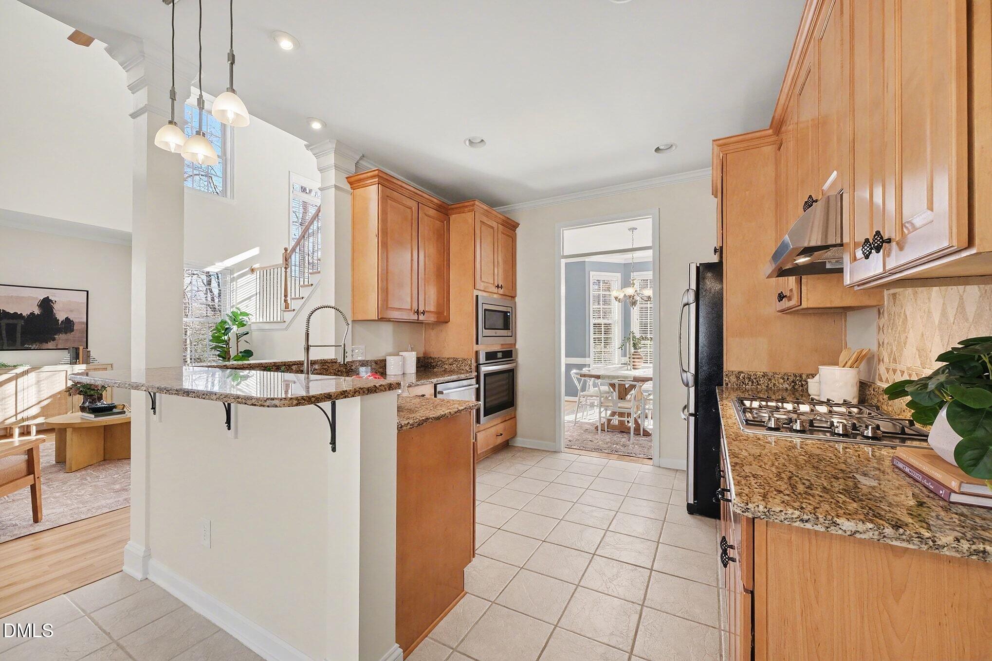 29 Chestnut Bluffs Lane Durham, NC 27713 - Photo 9 of 45 a kitchen with stainless steel appliances granite countertop a refrigerator and a stove top oven