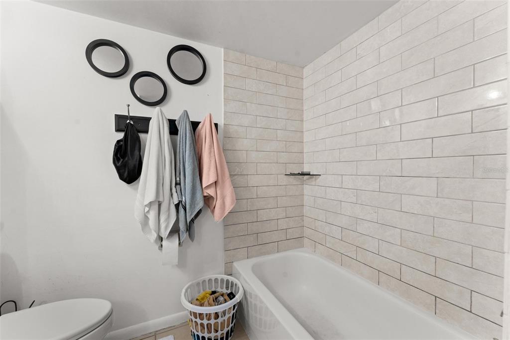 5201 Vineland Road, Unit 112 Orlando, FL 32811 - Photo 11 of 25 a bathroom with a sink a toilet and a shower