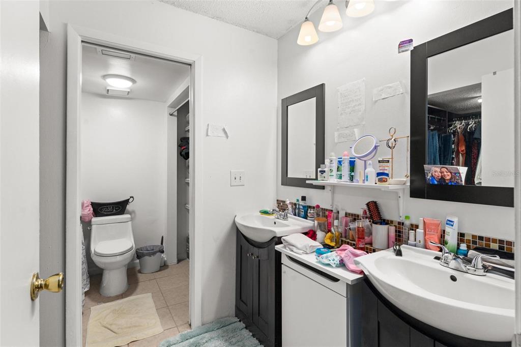 5201 Vineland Road, Unit 112 Orlando, FL 32811 - Photo 15 of 25 a bathroom with a sink toilet and mirror