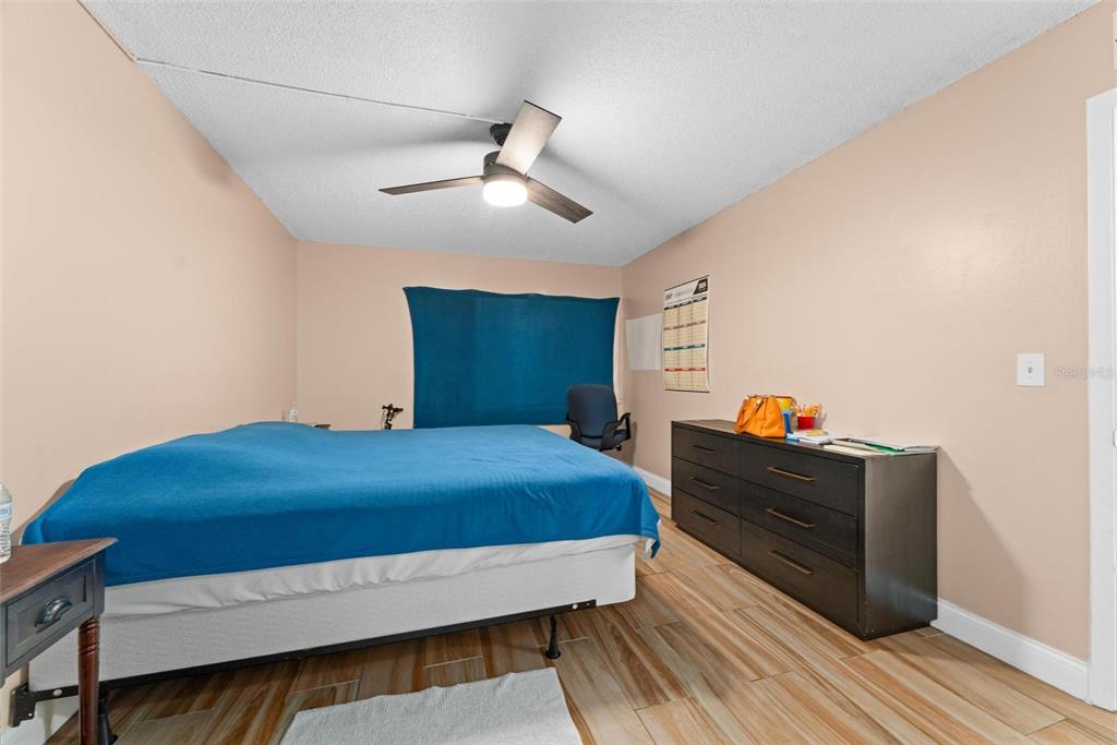 5201 Vineland Road, Unit 112 Orlando, FL 32811 - Photo 17 of 25 a bed room with a bed and a chandelier