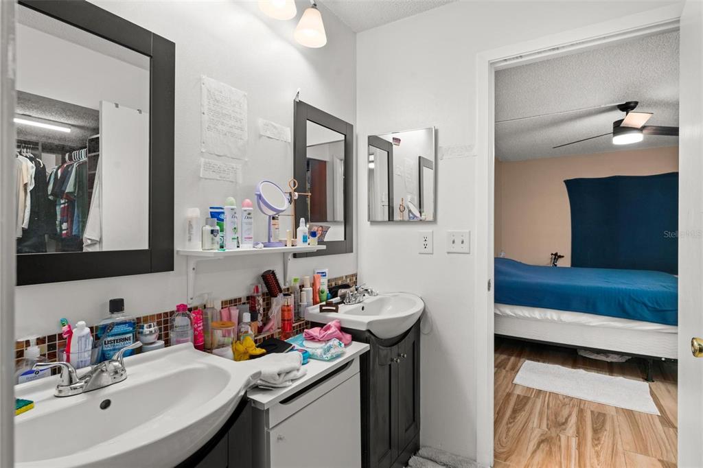 5201 Vineland Road, Unit 112 Orlando, FL 32811 - Photo 18 of 25 a bathroom with a sink double vanity and a mirror