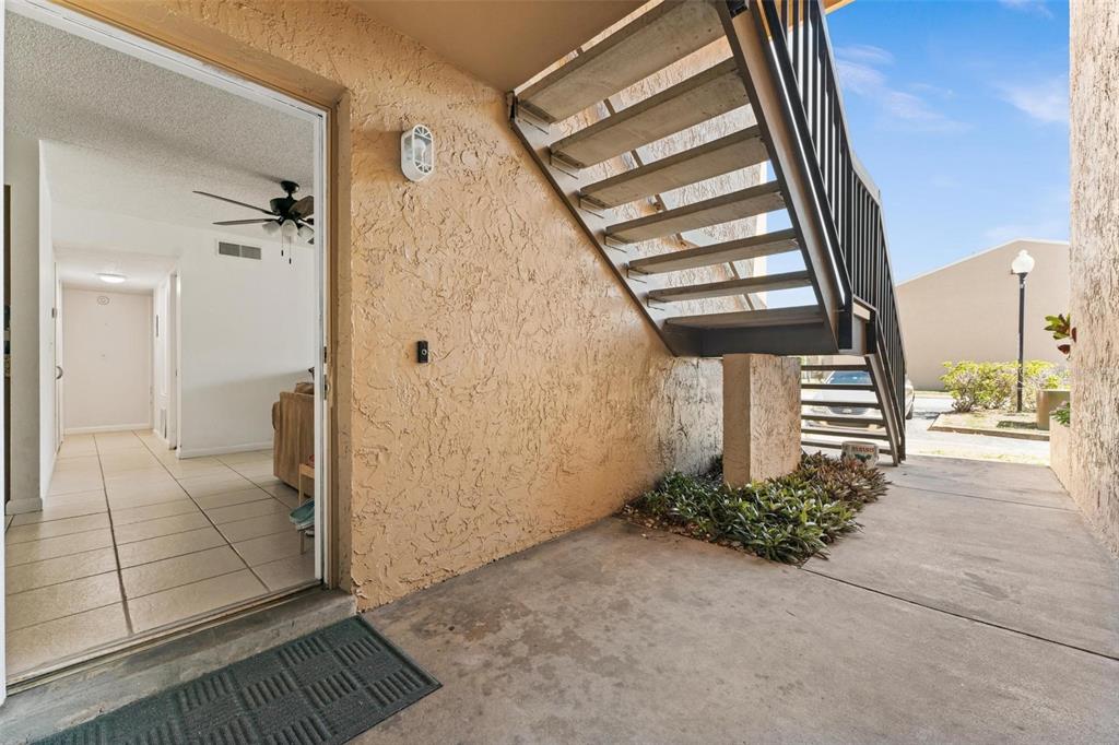 5201 Vineland Road, Unit 112 Orlando, FL 32811 - Photo 2 of 25 a view of entryway and hall with wooden floor