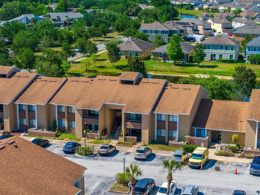 5201 Vineland Road, Unit 112 Orlando, FL 32811 - Photo 22 of 25 a view of a patio with couches table and chairs under an umbrella