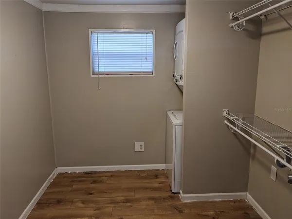 a view of a room with wooden floor