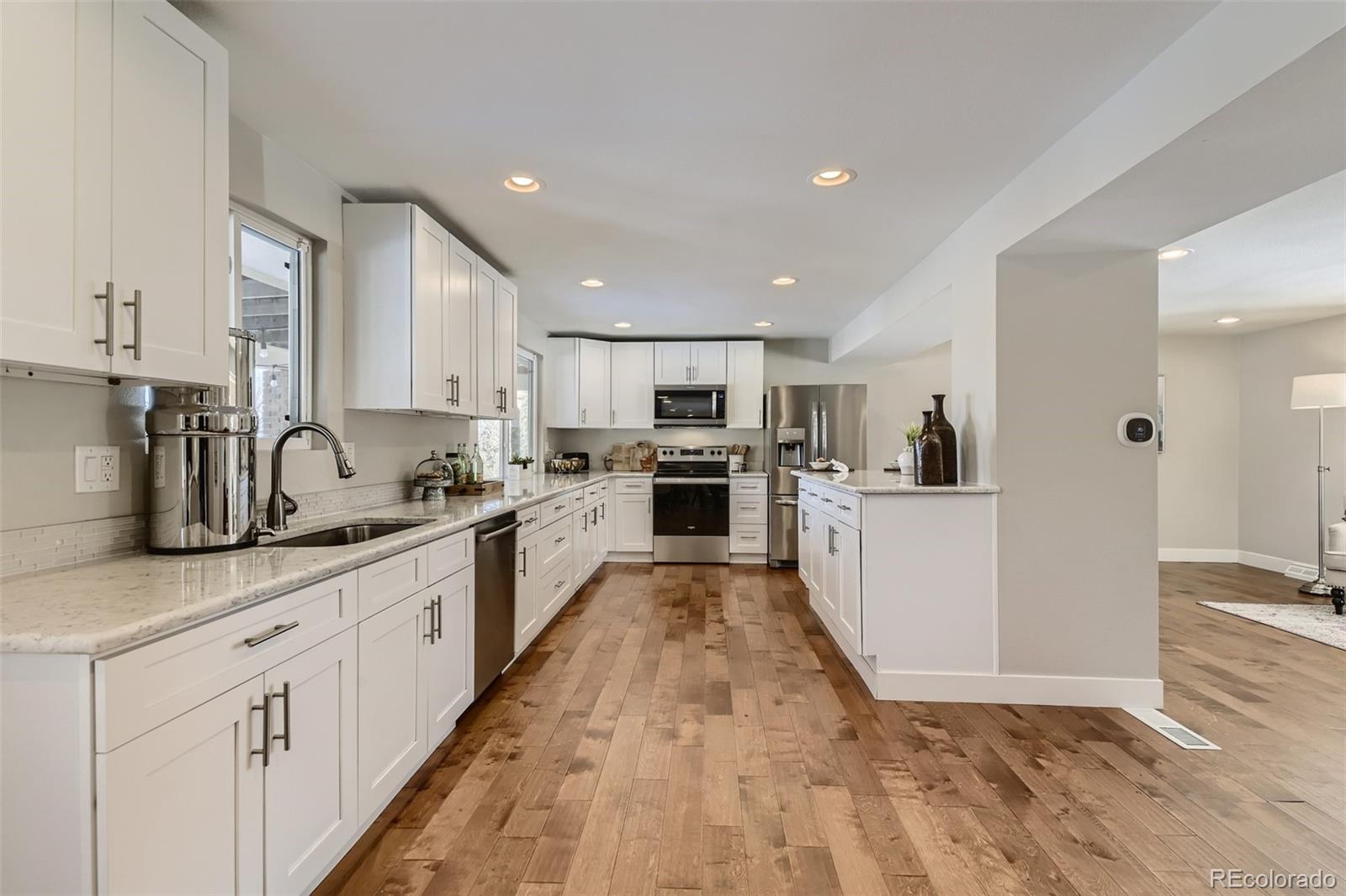 4165 East Peakview Circle Centennial, CO 80121 - Photo 1 of 27 a large kitchen with stainless steel appliances lots of counter top space and cabinets