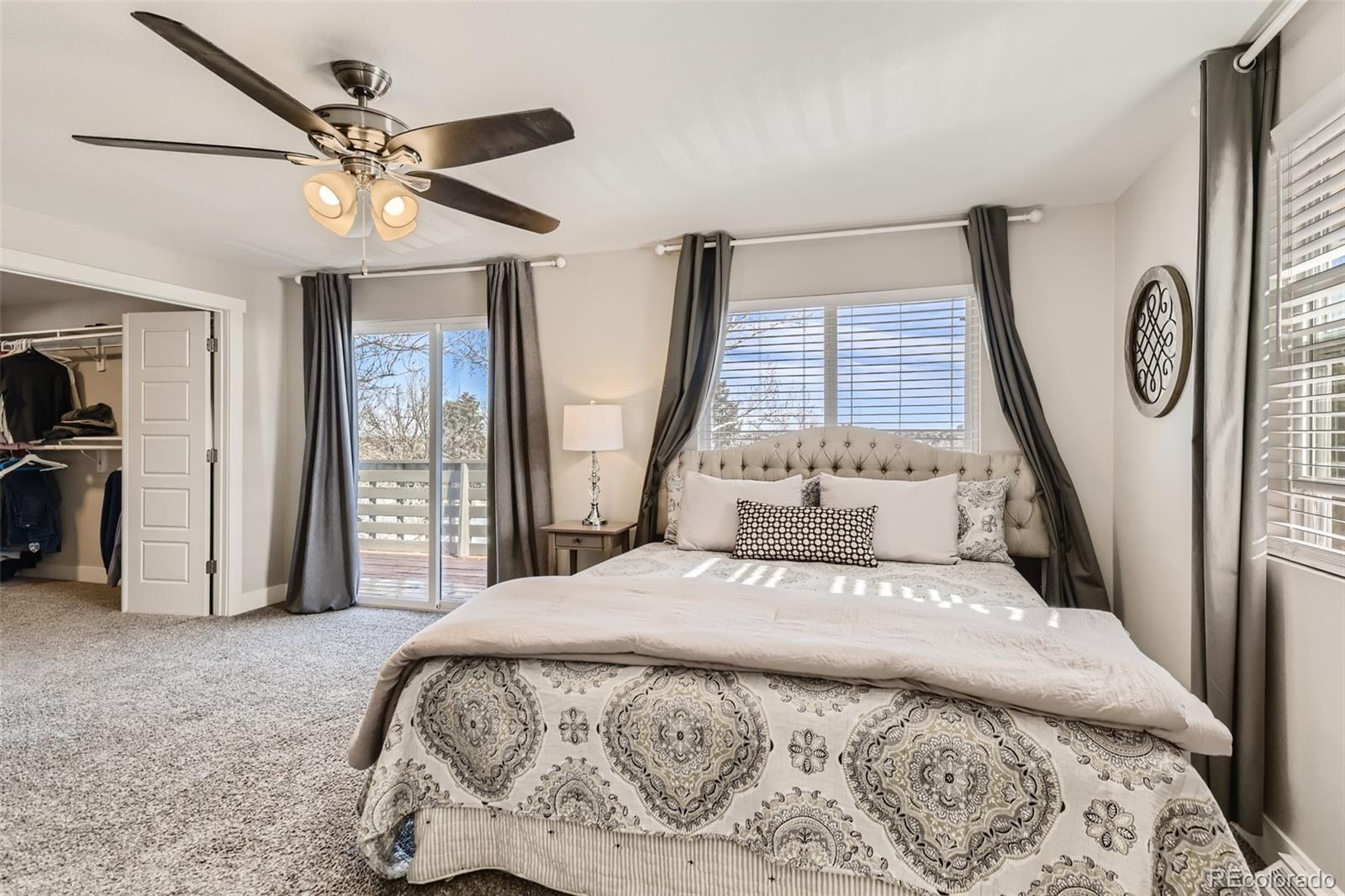 4165 East Peakview Circle Centennial, CO 80121 - Photo 14 of 27 a bedroom with a large bed and a chandelier