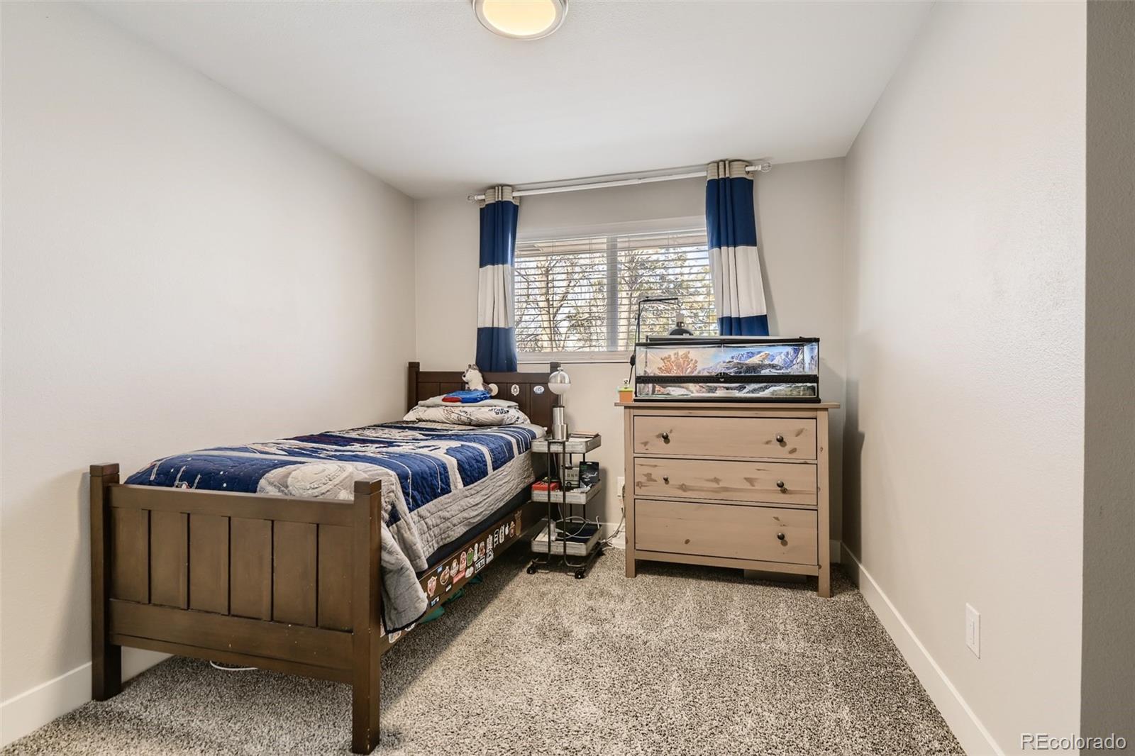 4165 East Peakview Circle Centennial, CO 80121 - Photo 15 of 27 a bedroom with a bed and a window