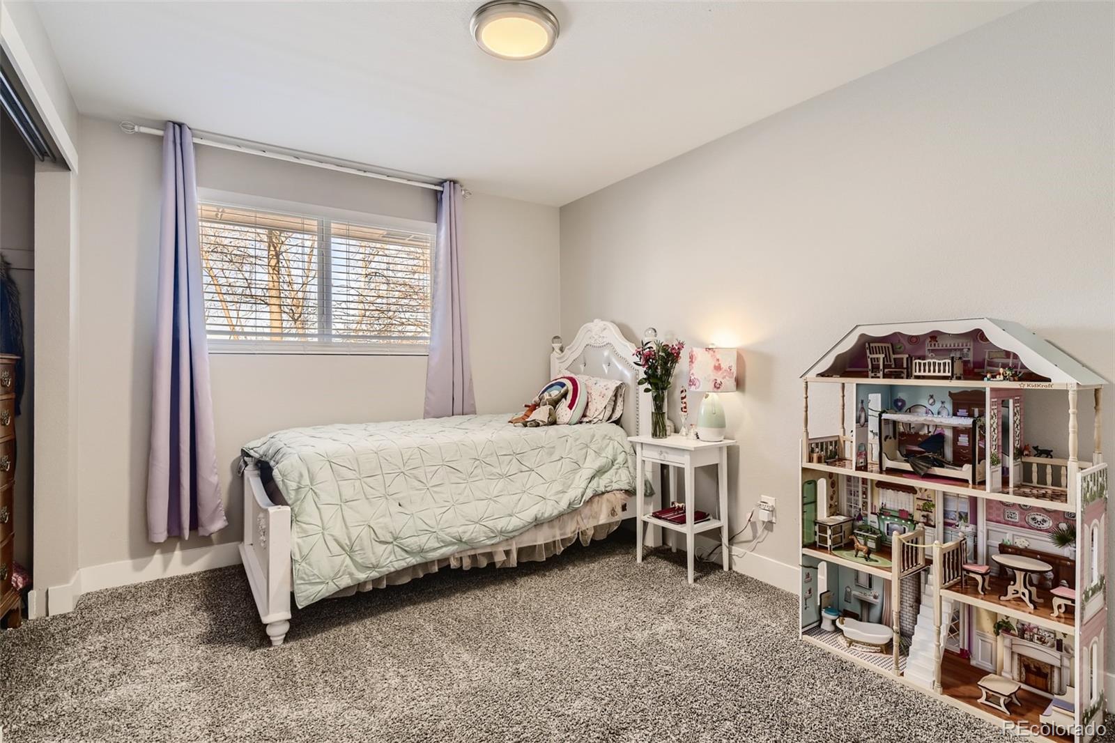 4165 East Peakview Circle Centennial, CO 80121 - Photo 16 of 27 a bedroom with a bed and a book shelf