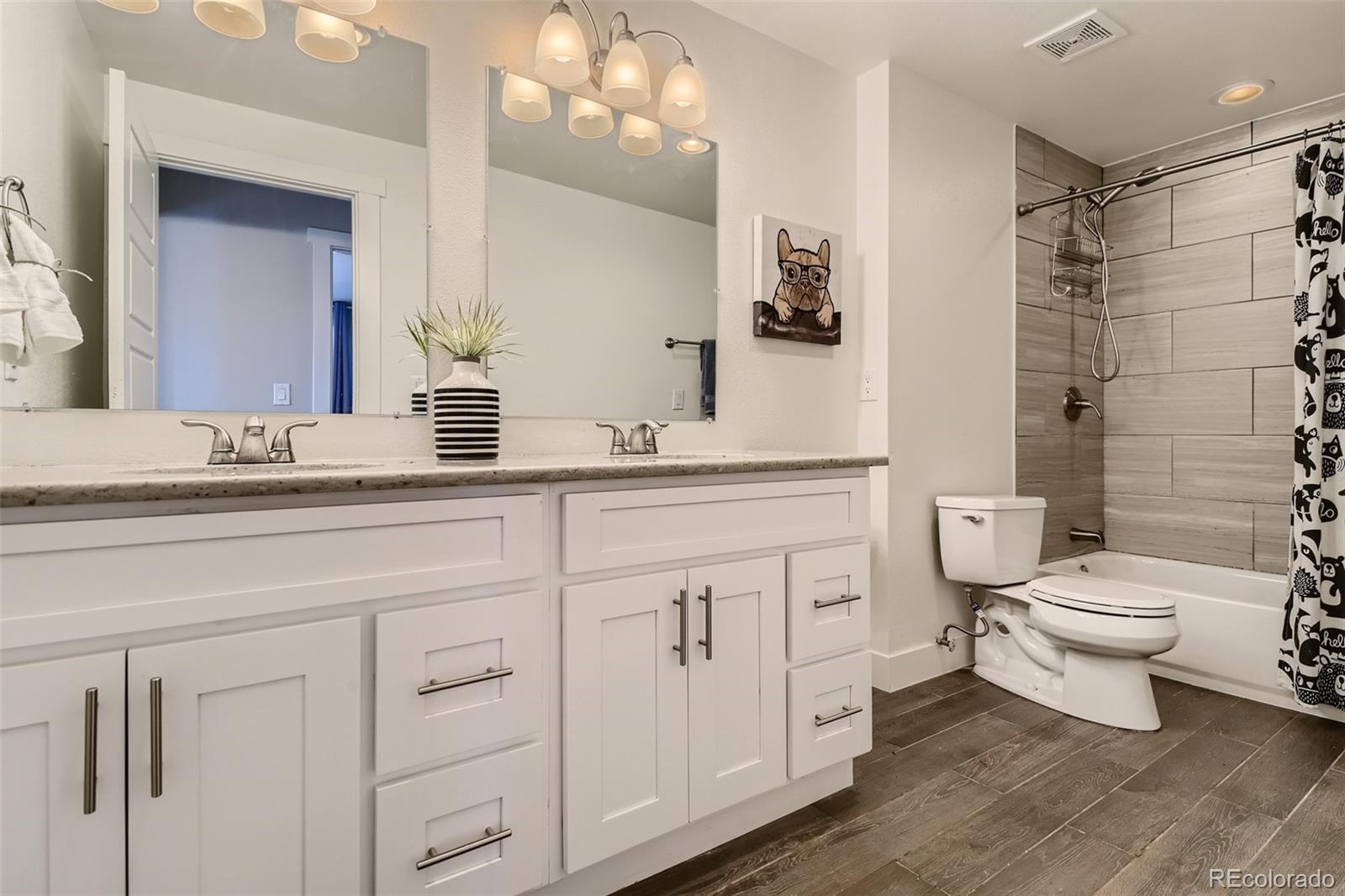 4165 East Peakview Circle Centennial, CO 80121 - Photo 17 of 27 a bathroom with a toilet sink and a mirror