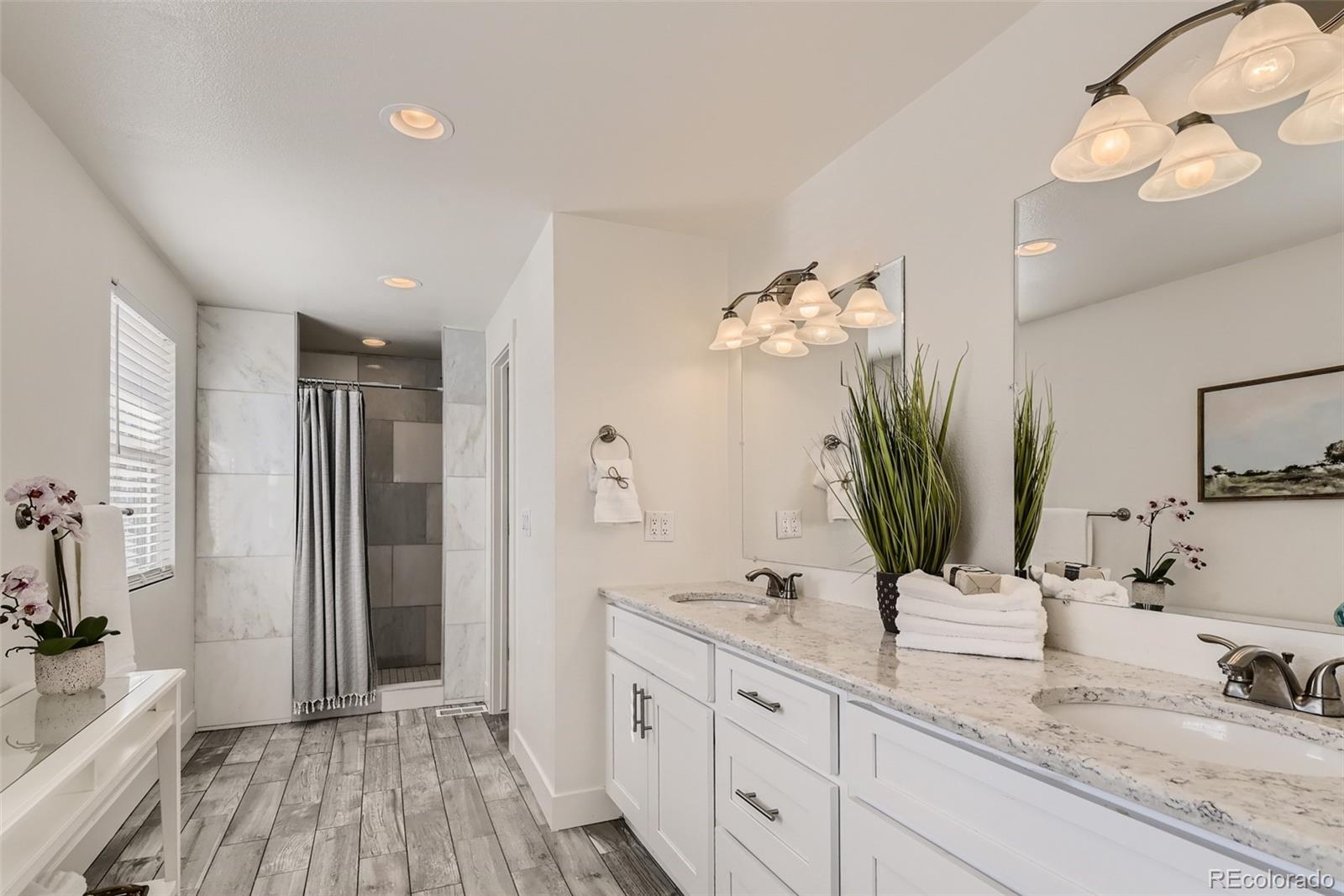 4165 East Peakview Circle Centennial, CO 80121 - Photo 20 of 27 a bathroom with a double vanity sink and a mirror