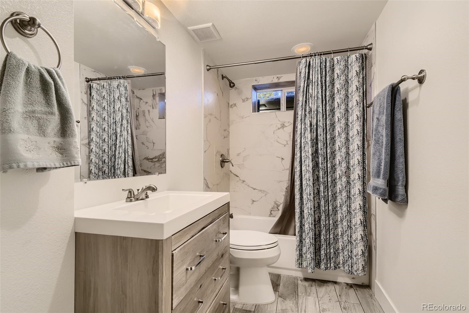 4165 East Peakview Circle Centennial, CO 80121 - Photo 22 of 27 a bathroom with a sink toilet and shower