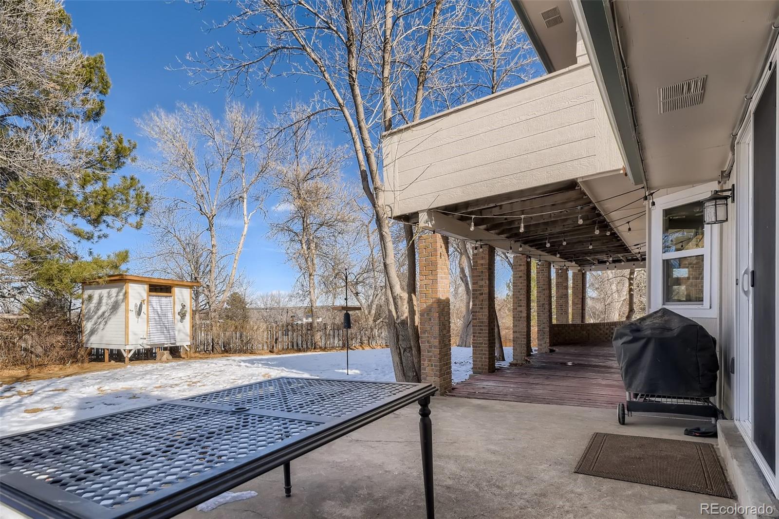 4165 East Peakview Circle Centennial, CO 80121 - Photo 24 of 27 a view of a porch with a table and chairs