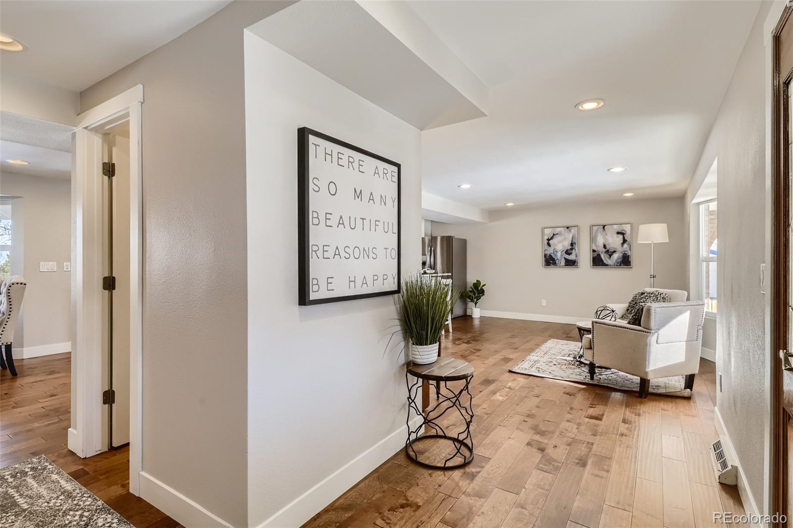 4165 East Peakview Circle Centennial, CO 80121 - Photo 4 of 27 a living room with furniture and a flat screen tv