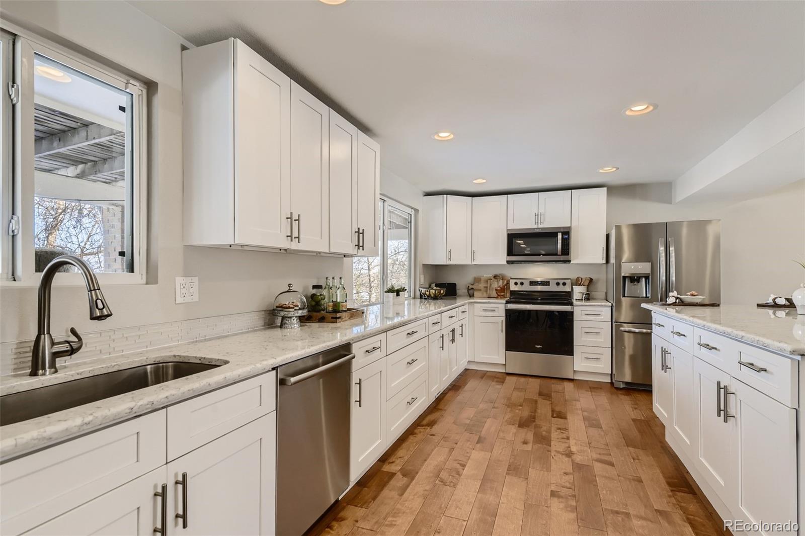 4165 East Peakview Circle Centennial, CO 80121 - Photo 8 of 27 a kitchen with appliances a sink cabinets and a window