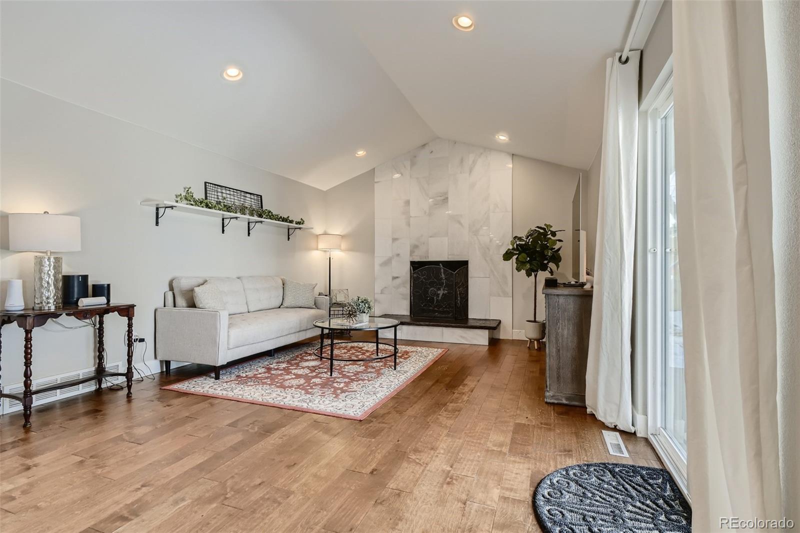 4165 East Peakview Circle Centennial, CO 80121 - Photo 10 of 27 a living room with furniture and a fireplace
