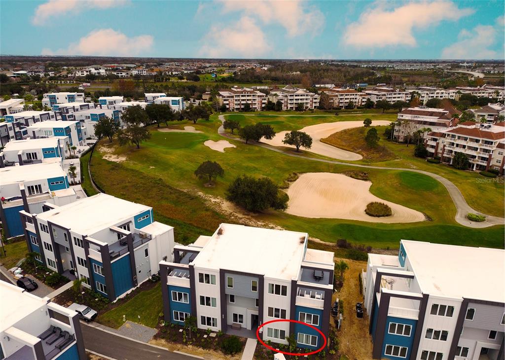 an aerial view of residential houses with outdoor space