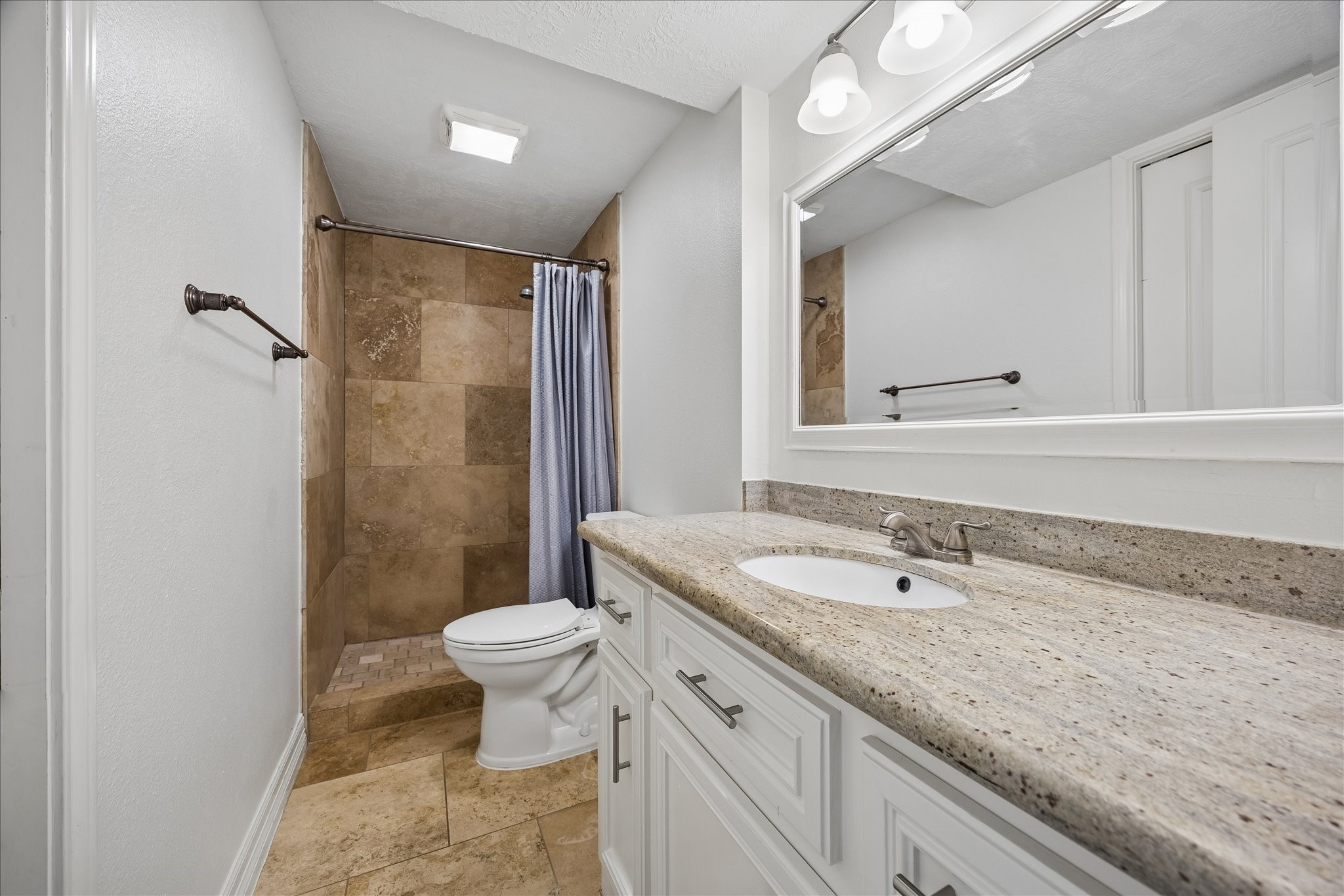 5019 Kinglet Street Houston, TX 77035 - Photo 24 of 24 Well-appointed first floor full bath boasts granite counters, undermount sink, framed mirror & upgraded hardware & plumbing fixtures. Rare floor plan boasts 3 full baths!