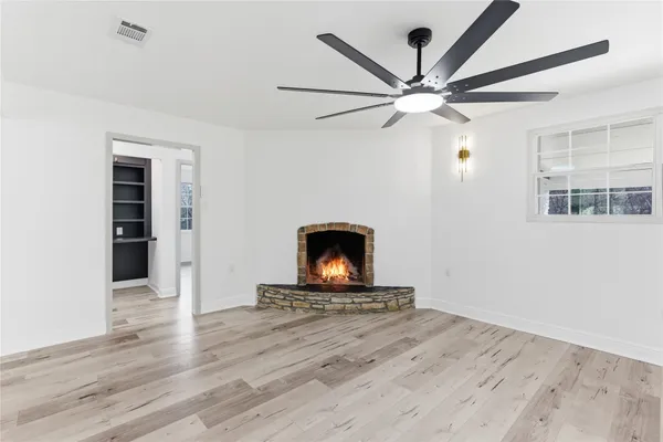 wooden floor in an empty room with a fireplace
