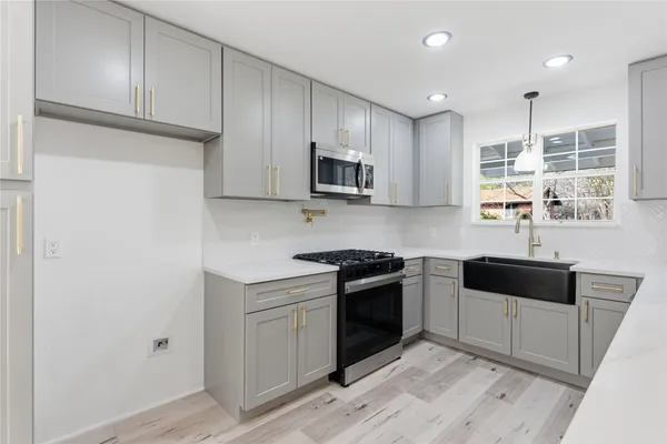 a view of a kitchen with wooden floor and a kitchen