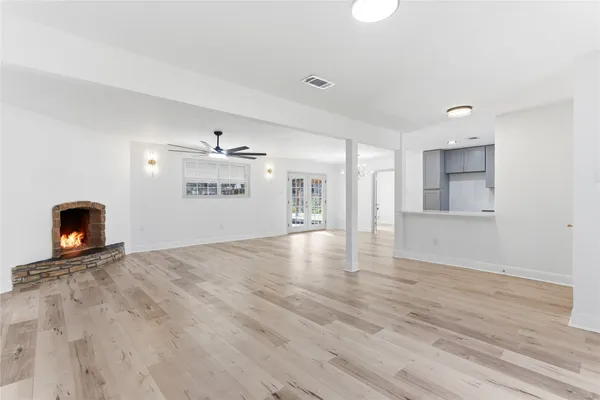 a view of an empty room and a fireplace