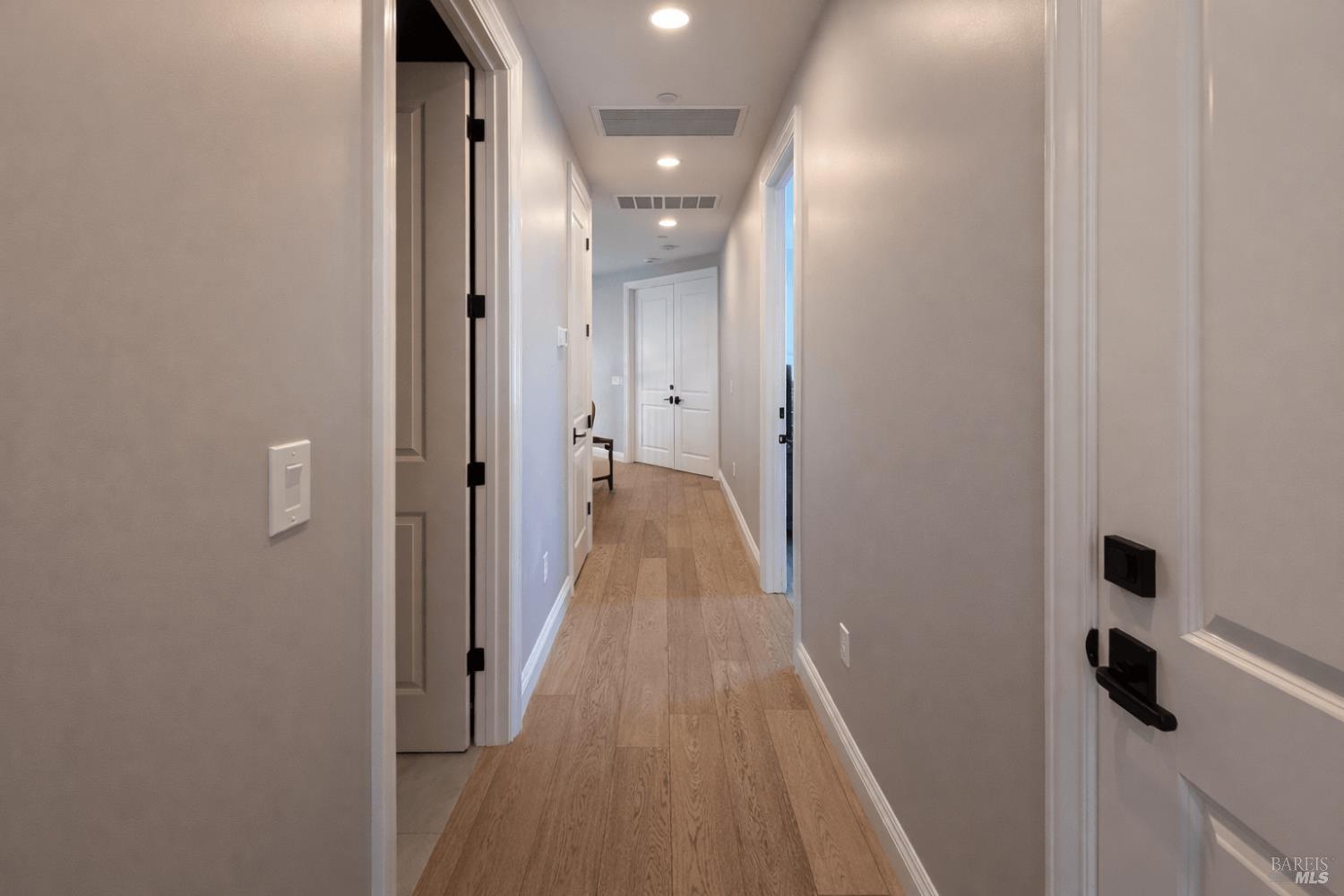 3726 Cannes Place Santa Rosa, CA 95403 - Photo 57 of 69 Here is a view of the upper-level hallway as seen from the front of the home, standing at the entrance to one of two secondary bedrooms. Door to the guest bathroom on the right, door to the laundry room is on the left.
