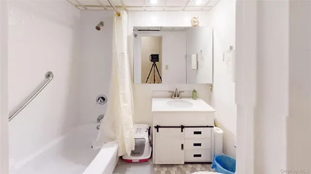 a bathroom with a sink a mirror and shower