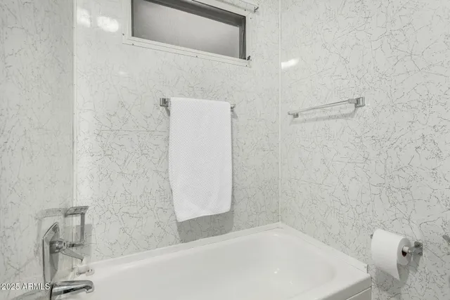 a bathroom with a bathtub and shower