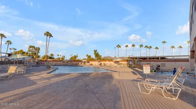 a view of a swimming pool with outdoor seating