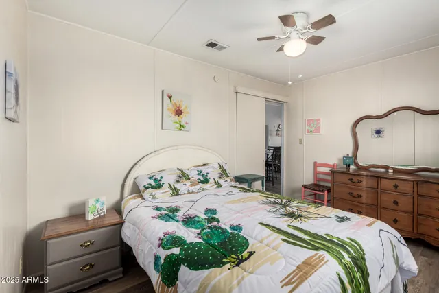 a bedroom with a bed dresser and a window