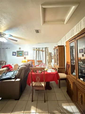 a view of a yard with plants and trees