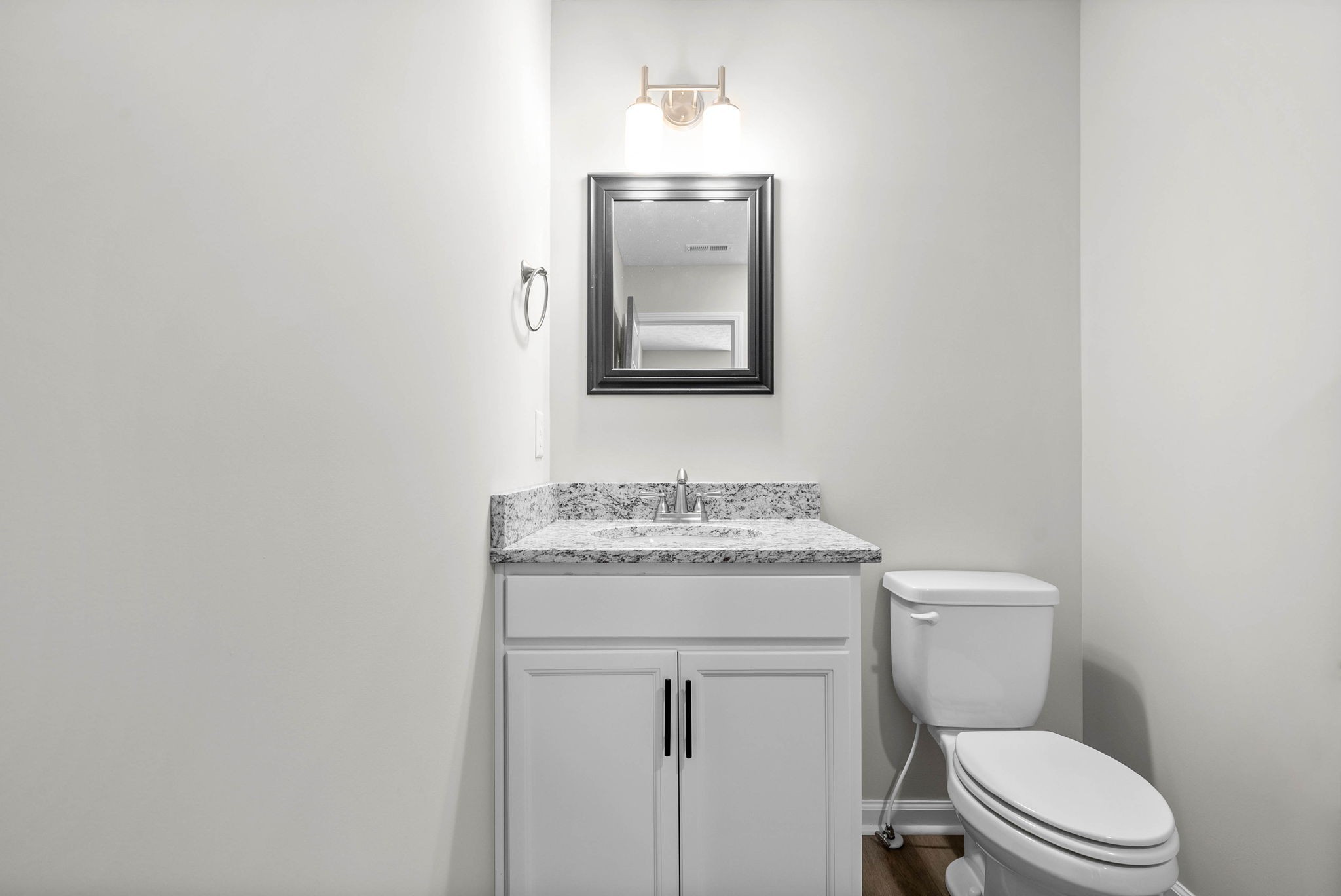317 Longshadow Trail, Unit F Clarksville, TN 37043 - Photo 18 of 30 a bathroom with a granite countertop toilet sink and mirror