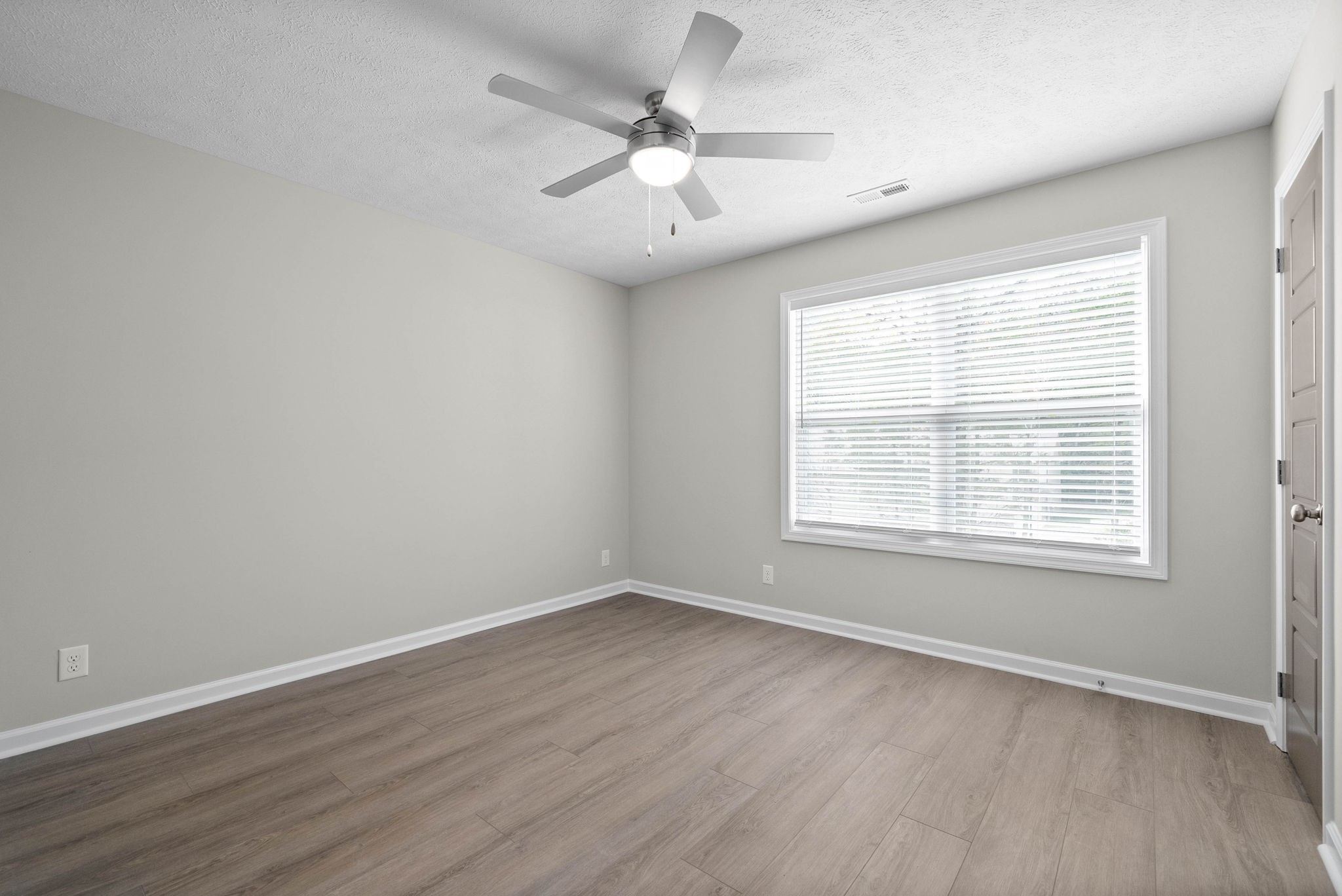 317 Longshadow Trail, Unit F Clarksville, TN 37043 - Photo 20 of 30 an empty room with wooden floor and windows