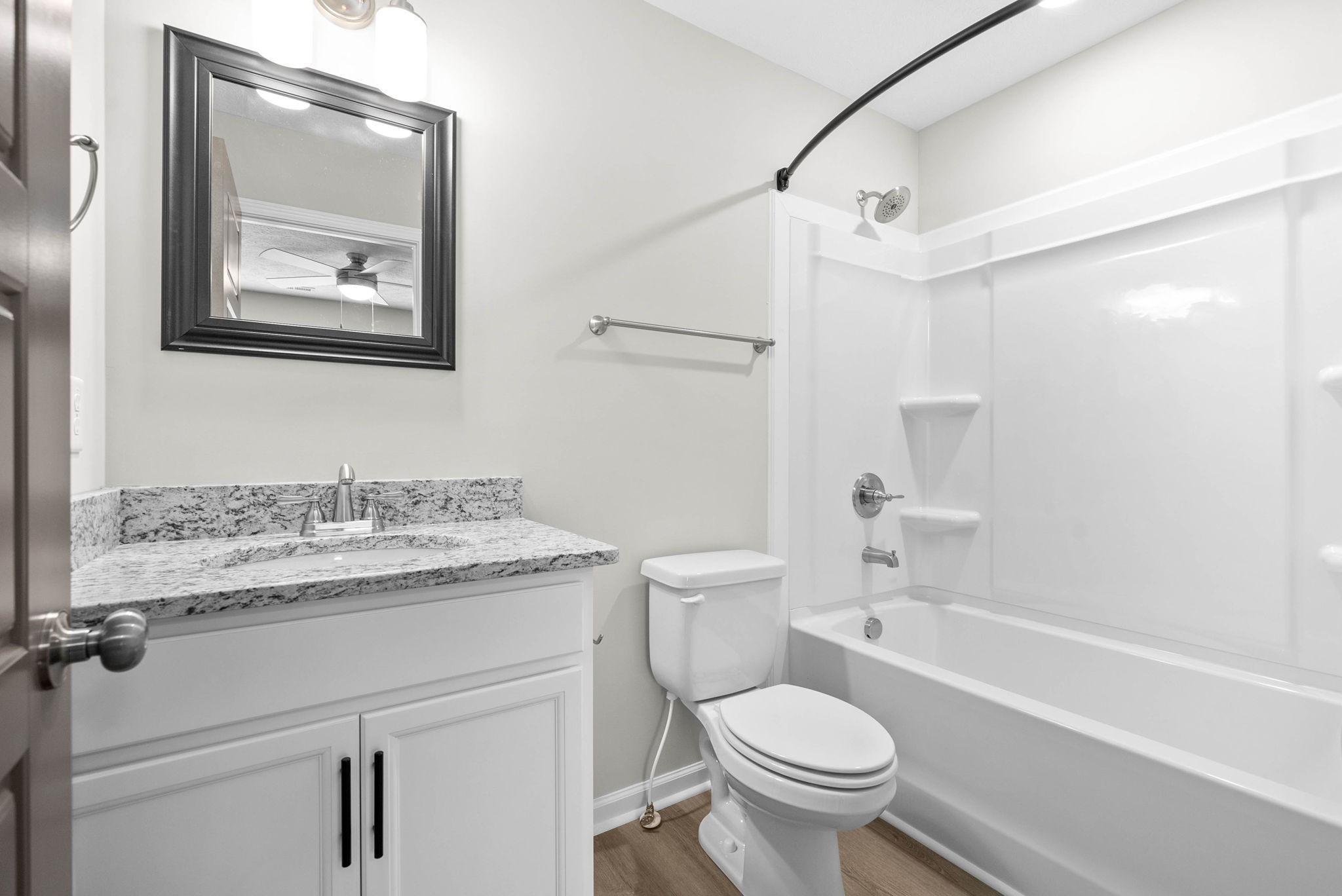 317 Longshadow Trail, Unit F Clarksville, TN 37043 - Photo 22 of 30 a bathroom with a granite countertop toilet a sink and a bathtub