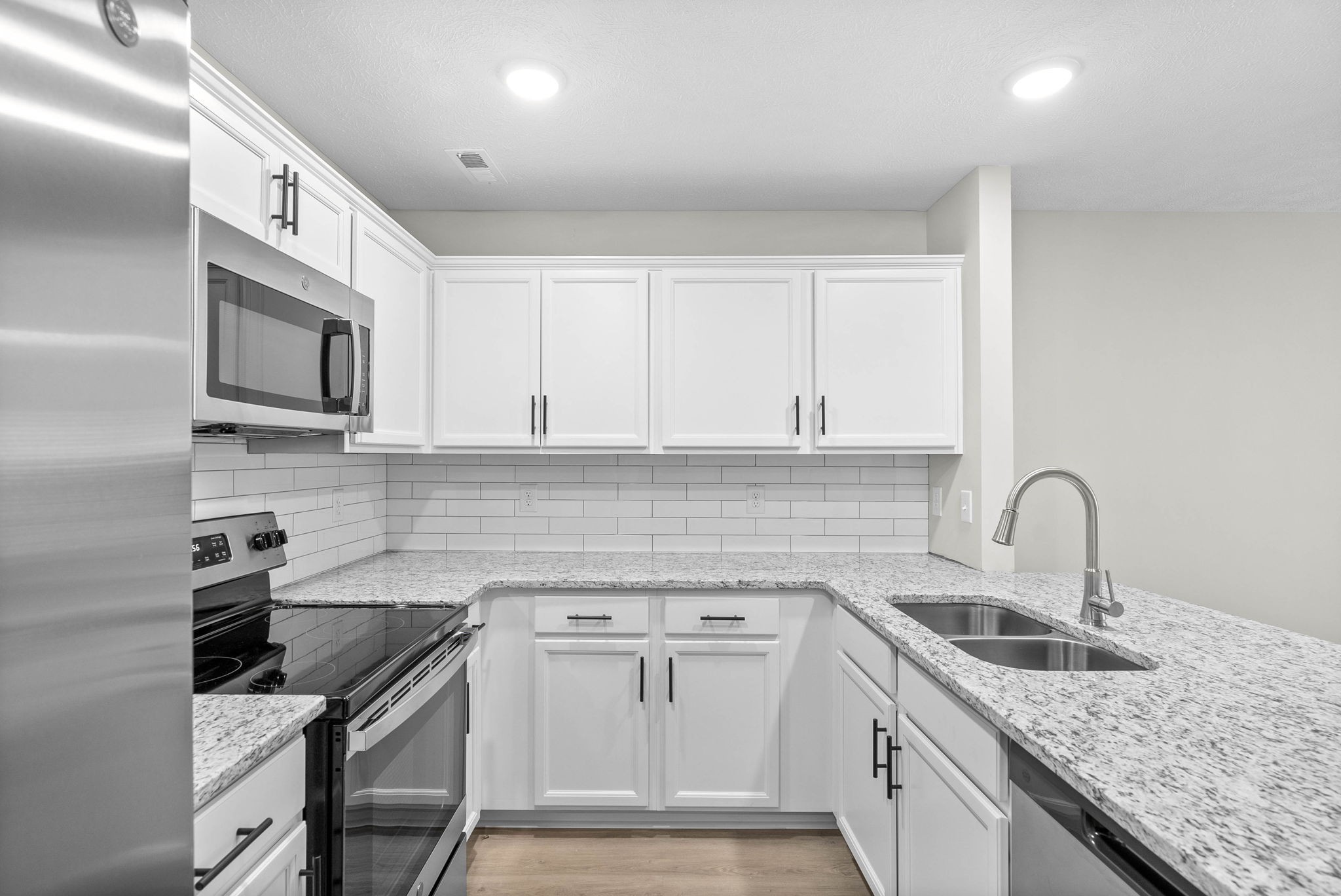 317 Longshadow Trail, Unit F Clarksville, TN 37043 - Photo 8 of 30 a kitchen with stainless steel appliances granite countertop a sink stove and refrigerator