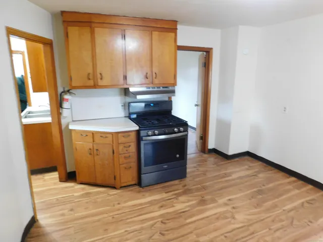 a kitchen with a stove a sink and a window