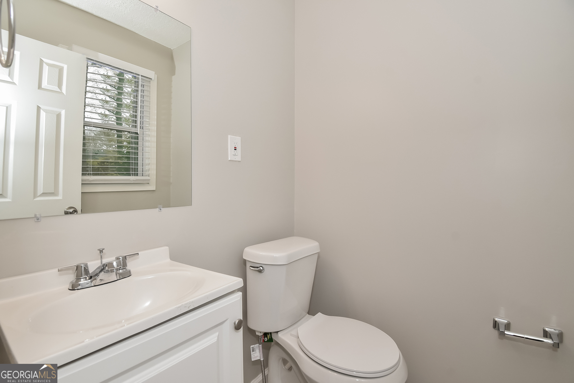 3803 Bakers Ferry Road Southwest Atlanta, GA 30331 - Photo 14 of 16 a bathroom with a sink a toilet and a mirror