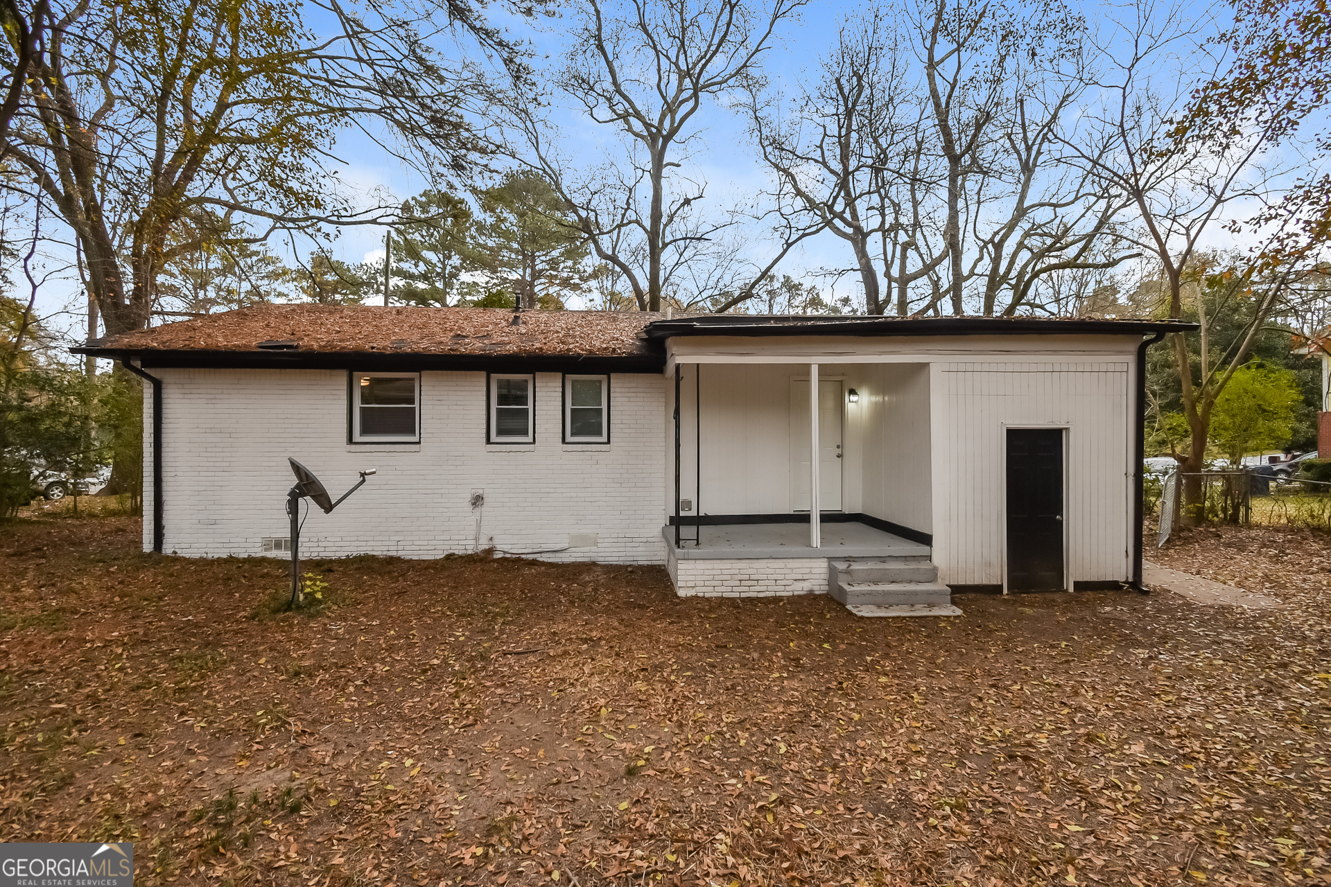 3803 Bakers Ferry Road Southwest Atlanta, GA 30331 - Photo 15 of 16 a house with trees in the background
