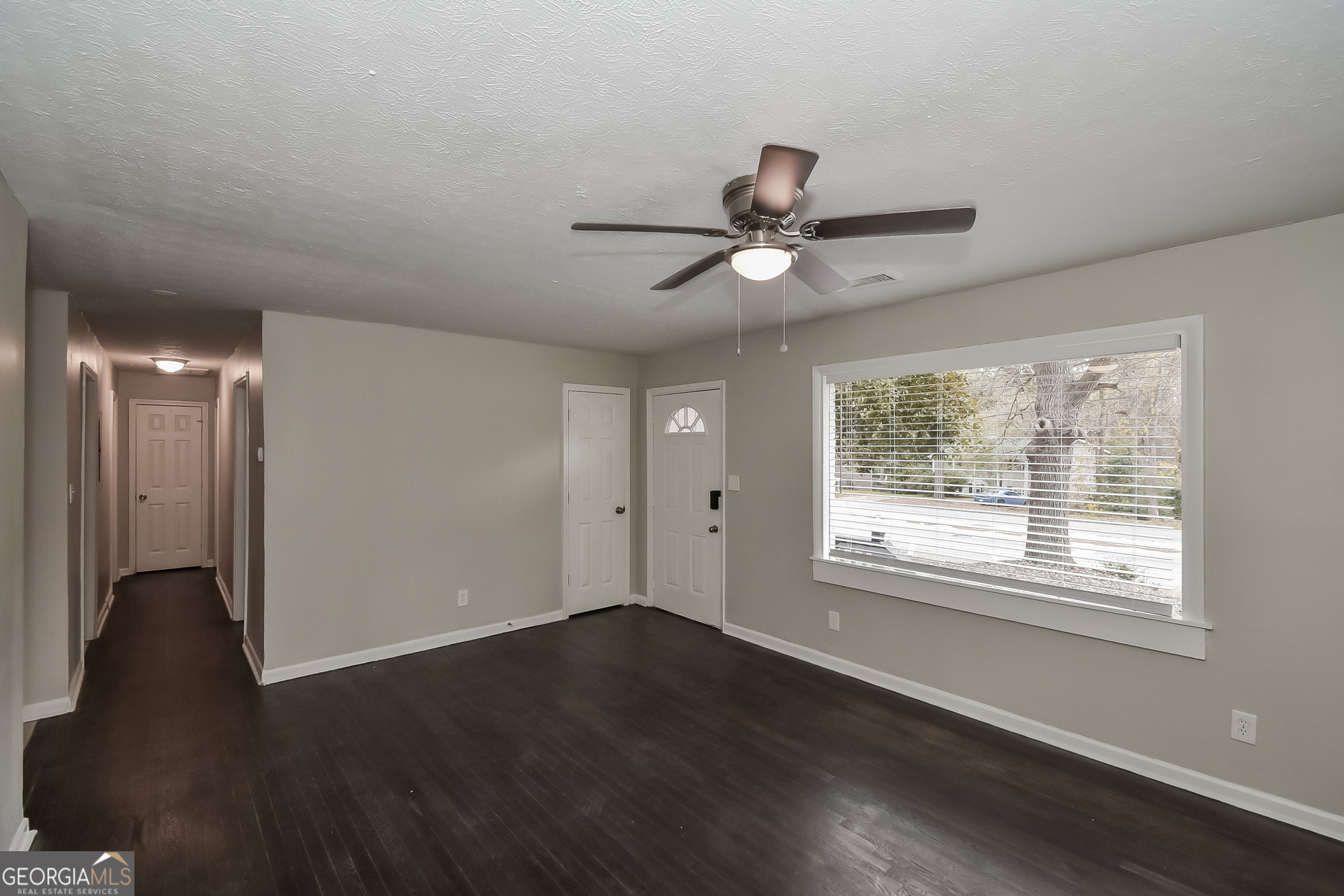 3803 Bakers Ferry Road Southwest Atlanta, GA 30331 - Photo 3 of 16 a view of an empty room with wooden floor and a window