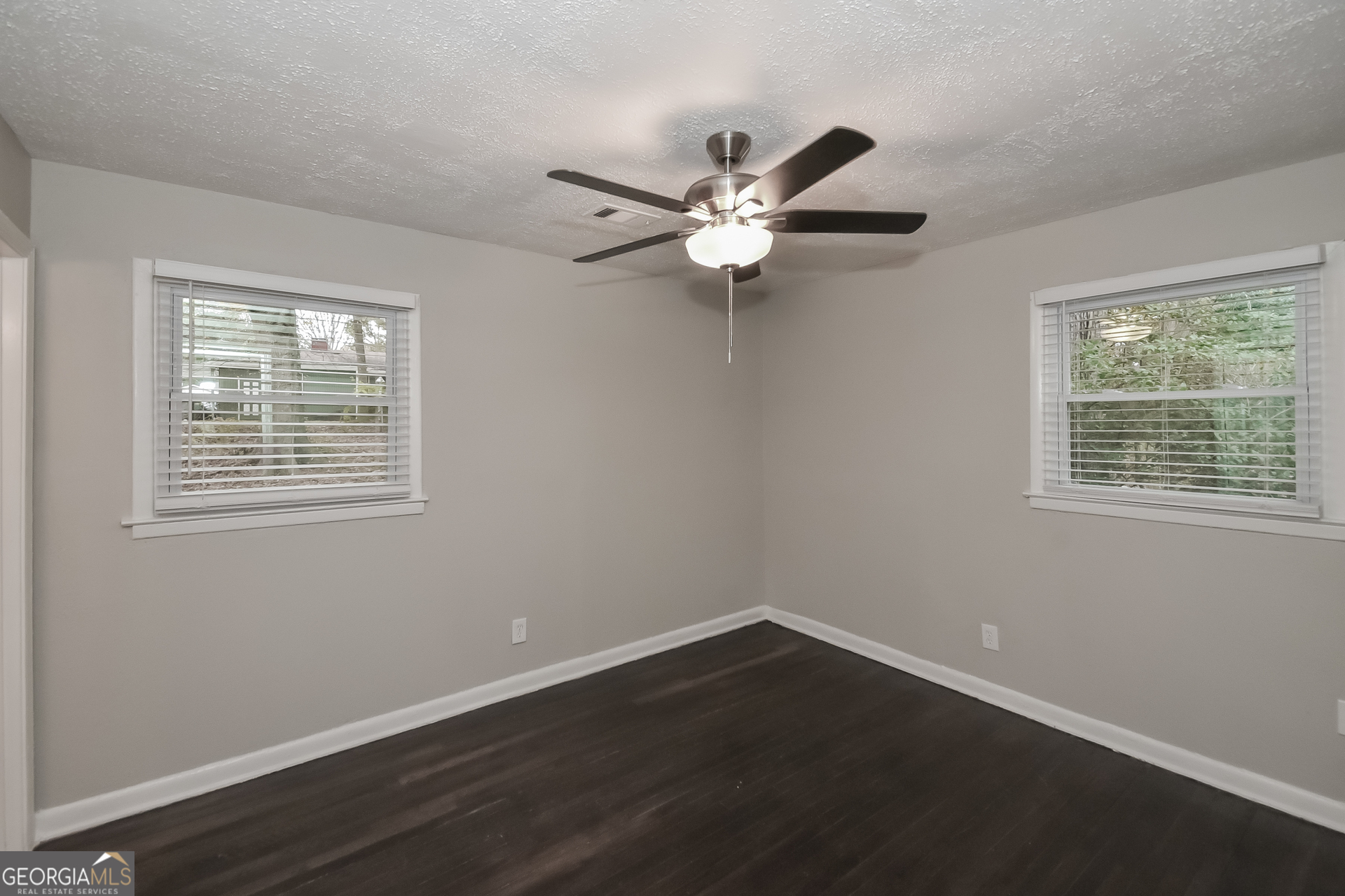 3803 Bakers Ferry Road Southwest Atlanta, GA 30331 - Photo 6 of 16 a view of an empty room with wooden floor and a window