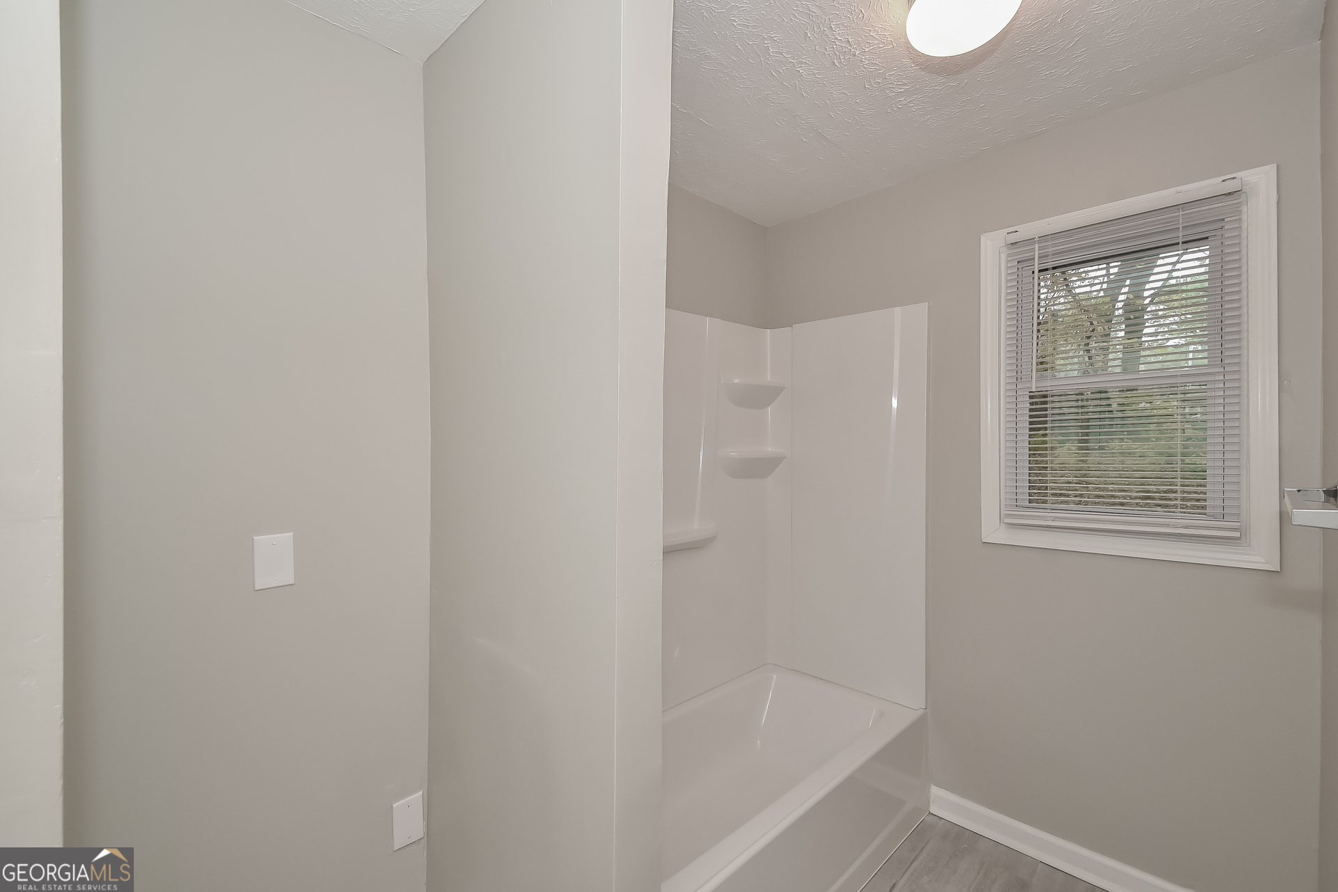 3803 Bakers Ferry Road Southwest Atlanta, GA 30331 - Photo 8 of 16 a bathroom with a bathtub