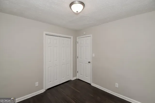 a view of room with wooden floor