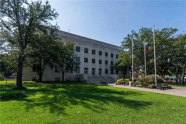 a view of a building with a yard